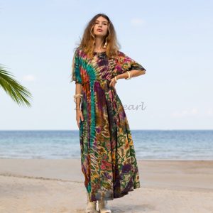 Celebrate your unique style with our Kalina Bliss Tie Dye Maxi Dress! Show off your true self in boho-inspired, plus-size fashion from Zinnia Pearl. Our inclusive and affordable line lets you express yourself authentically with each exquisite piece. * Handmade Kalina Bliss Tie Dye Maxi Dress: Designed with love and crafted with care, this exquisite dress is a must-have for self-expression. * Vibrant and Joyful: Radiate positivity with the dress's exuberant tones and vibrant hues. * Unique Baby Doll Silhouette: Stand out from the crowd with a dress that embodies individuality. * Finest Quality Jersey Fabric: Experience the softness against your skin and admire the eye-catching tie-dye design. * Boho-Chic Elegance: Add a touch of vintage Italian design to your look with the fashionable tint. * Perfect for Any Occasion: Whether it's a festival or a sunny day, this dress is a go-to choice. * Comfortable and Stylish: Featuring a pull-over style, flowing floor-length hem, and drop shoulder sleeves. * Inclusive Sizing: We cater to our beautiful plus-size community with one inclusive sizing option up to 1-2X * 100% Cotton: Experience comfort and breathability in this natural fabric. * Embrace Variations: Each dress is unique due to the tie-dye technique, showcasing the artisanal craftsmanship.